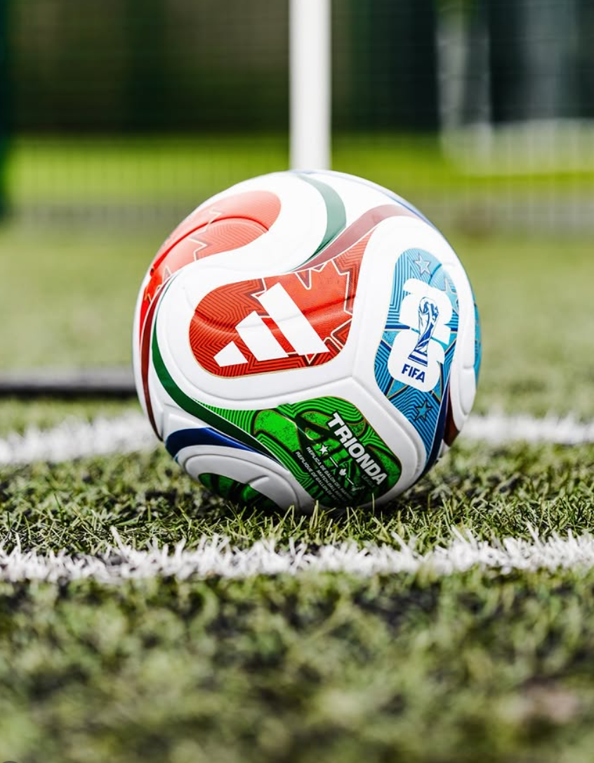 Adidas Trionda matchball resting on the pitch line