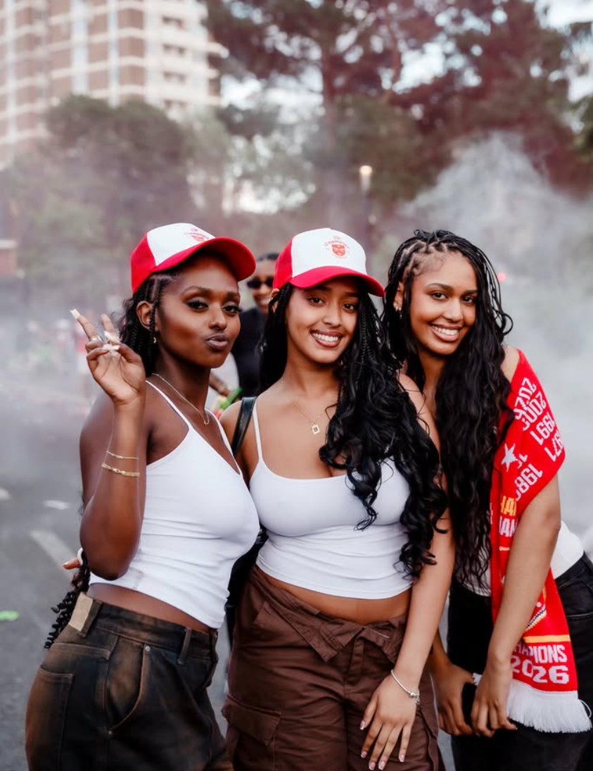 Three Arsenal supporters photographed in the parade haze
